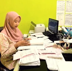 Staf administrasi JDP bekerja di meja kantor